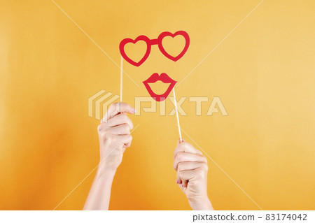 Paper party attributes on wooden stick. Carnival accessory concept. 83174042