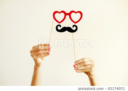 Paper party attributes in form of moustache on wooden stick. Carnival accessory concept. 83174051