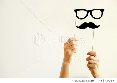 Paper party attributes in form of moustache on wooden stick. Carnival accessory concept. 83174057