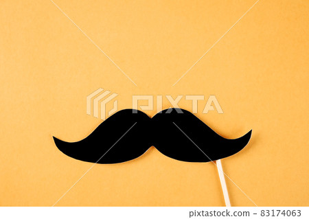 Paper party attributes in form of mustache on wooden stick. Carnival accessory concept. Paper party attributes in form of mustache on wooden stick. Carnival accessory concept. 83174063