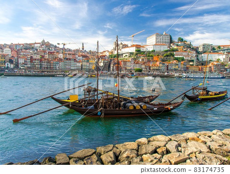 Portugal, Porto, wooden boats with wine barrels on Douro river close up, wooden boats 83174735