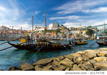 Portugal, Porto, wooden boats with wine barrels on Douro river close up, wooden boats 83174736