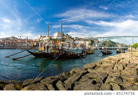 Portugal, Porto, wooden boats with wine barrels on Douro river close up, wooden boats 83174738