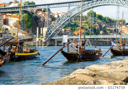 Portugal, Porto, wooden boats with wine barrels on Douro river close up, wooden boats 83174739