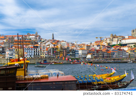 Portugal, Porto, colored houses of old town in Porto, colorful boats on Douro river 83174741