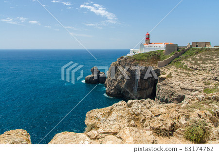 Portugal, Algarve, view of cliffs of Moher and Atlantic Ocean, white red lighthouse, lighthouse near Sagres in Portugal, Cape St. Vincent Portugal, Algarve, view of cliffs of Moher and Atlantic Ocean, white red lighthouse, lighthouse near Sagres in Portugal, Cape St. Vincent 83174762
