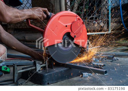 Worker cut steel with cut off wheel saw, cutting wheels. Worker cut steel with cut off wheel saw, cutting wheels. 83175198