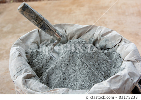 .Cement powder and trowel put in bag package.. .Cement powder and trowel put in bag package.. 83175238
