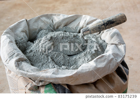 .Cement powder and trowel put in bag package.. .Cement powder and trowel put in bag package.. 83175239