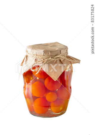 Pickled tomatoes in a glass jar isolated on a white background. Fermented trending food. Homemade preserves. 83175824