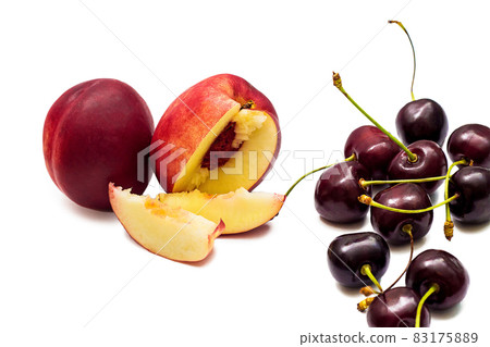 Juicy red nectarine and ripe sweet cherries isolated on white background 83175889