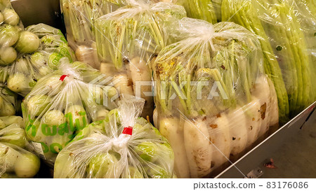 Vegetables are in plastic bags in shelves for sale. Vegetables are in plastic bags in shelves for sale. 83176086