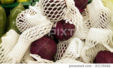 Purple cabbage wrapped in white foam cushioning Purple cabbage wrapped in white foam cushioning 83176088
