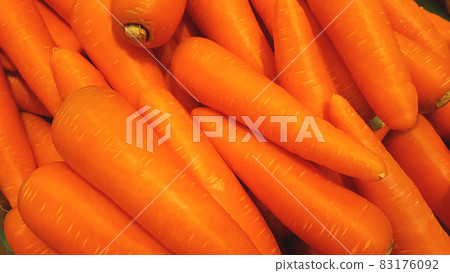 Many carrots are placed together in the shop for sale. Many carrots are placed together in the shop for sale. 83176092