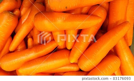 Many carrots are placed together in the shop for sale. Many carrots are placed together in the shop for sale. 83176093