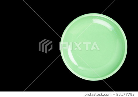 Green ceramic plate on black background Green ceramic plate on black background 83177792