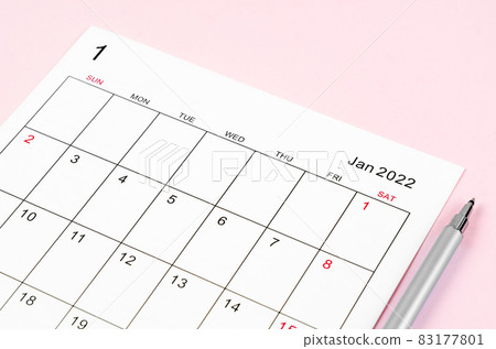 January 2022 calendar sheet with pen on pink background. 83177801