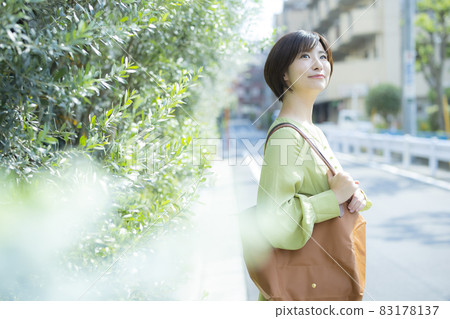 A woman walking outdoors A woman walking outdoors 83178137