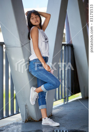 Outdoor portrait of young Asian woman posing in the corridor 83178533
