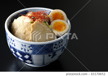 A chicken char siu bowl with boiled egg, all-purpose green onion and thread-cut chili pepper on a black background A chicken char siu bowl with boiled egg, all-purpose green onion and thread-cut chili pepper on a black background 83178652
