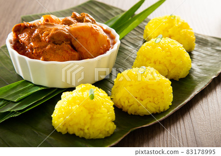Nasi Kunyit also known as Turmeric Glutinous Rice. Normally eaten with dry curry chicken. Nasi Kunyit also known as Turmeric Glutinous Rice. Normally eaten with dry curry chicken. 83178995