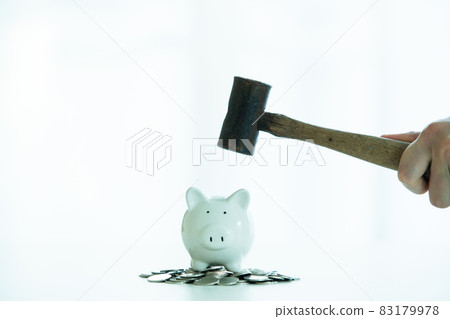 Smashing a piggy saving. 83179978