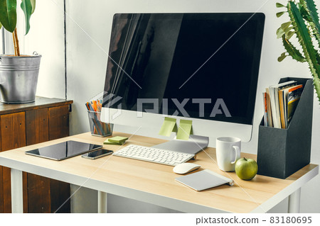 Office or home workspace. Computer monitor with black screen on office table with supplies Office or home workspace. Computer monitor with black screen on office table with supplies 83180695