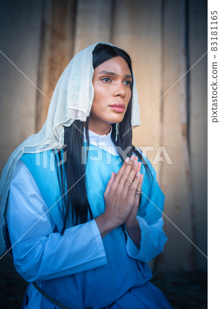 Transsexual virgin praying with her gaze lost Transsexual virgin praying with her gaze lost 83181165