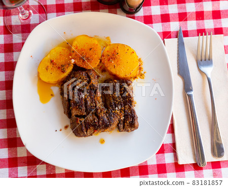 Grilled veal in chimmichurri with potatoes al Caliu Grilled veal in chimmichurri with potatoes al Caliu 83181857