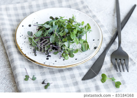 Assortment of micro greens on concrete background 83184168