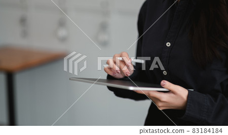 Close up view of graphic designer drawing on digital tablet at office Close up view of graphic designer drawing on digital tablet at office 83184184