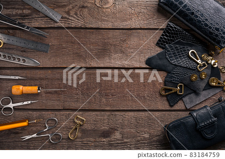Leather products. Work place craftsman in a workshop. Top view Leather products. Work place craftsman in a workshop. Top view 83184759