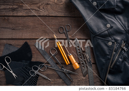 Leather craft or leather working. Leather working tools and cut out pieces of leather on work desk . Leather craft or leather working. Leather working tools and cut out pieces of leather on work desk . 83184766