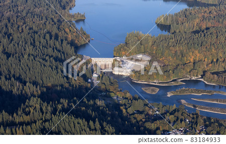 Aerial view from airplane of a water dam by Hayward Lake. 83184933