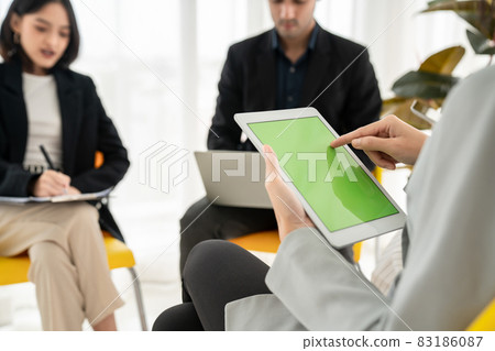 Businesswoman in business meeting using computer proficiently at office room . Businesswoman in business meeting using computer proficiently at office room . 83186087
