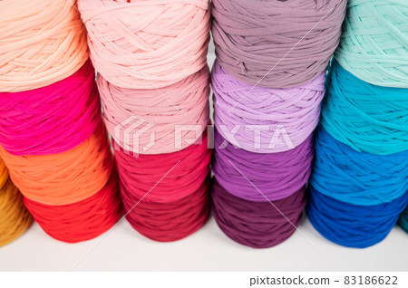 Rows of multicolored cotton yarn. The assortment of the store for needlework. Rows of multicolored cotton yarn. The assortment of the store for needlework. 83186622