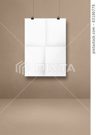 White folded poster hanging on a beige wall with clips White folded poster hanging on a beige wall with clips 83186778