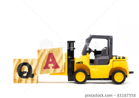 Toy forklift hold letter block a to complete word QA (abbreviation of quality assurance or question and answer) on wood background Toy forklift hold letter block a to complete word QA (abbreviation of quality assurance or question and answer) on wood background 83187358