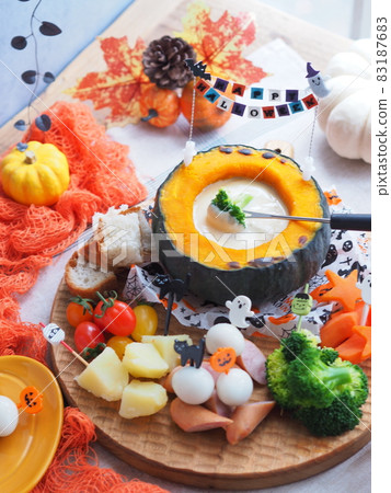 Happy Halloween pumpkin bowl with cheese fondue 83187683