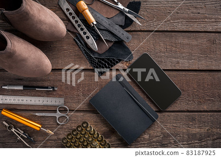 Leather products. Work place craftsman in a workshop. Top view Leather products. Work place craftsman in a workshop. Top view 83187925