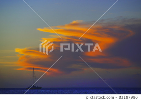 A Sailing Boat with orange sunset cloud 83187980