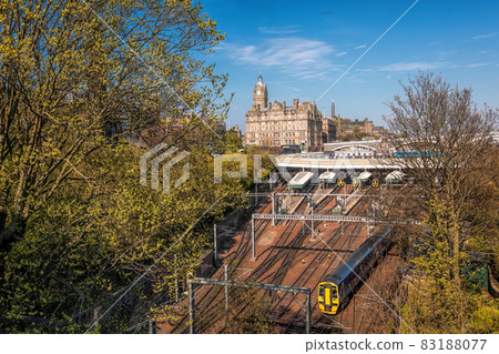 Edinburgh Waverley railway station with trains against Clock Tower building in Scotland, United Kingdom 83188077