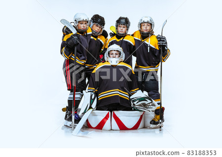 Full-length portrait of boys, children, professional hockeys player isolated over white background. Friendship 83188353