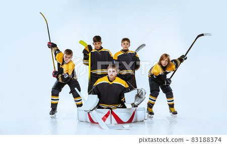 Full-length portrait of boys, children, professional hockeys player isolated over white background. Team game Full-length portrait of boys, children, professional hockeys player isolated over white background. Team game 83188374