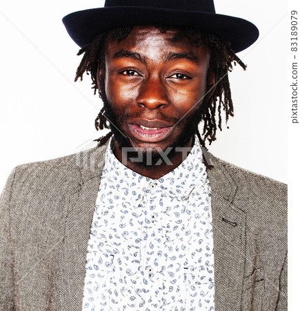 young handsome afro american boy in stylish hipster hat gesturing emotional isolated on white background smiling, lifestyle people concept 83189079