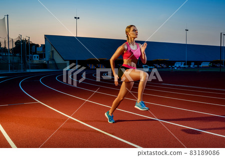Runner sprinting towards success on run path running athletic track. Goal achievement concept. 83189086