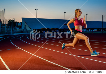 Runner sprinting towards success on run path running athletic track. Goal achievement concept. 83189089