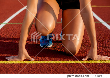 Close-up of woman's legs on start before jogging Close-up of woman's legs on start before jogging 83189100