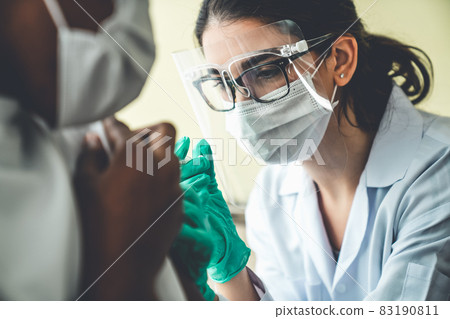 Young man visits skillful doctor at hospital for vaccination Young man visits skillful doctor at hospital for vaccination 83190811