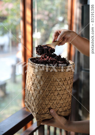 Boiled riceberry rice on wood basket with spoon in close up Boiled riceberry rice on wood basket with spoon in close up 83191386